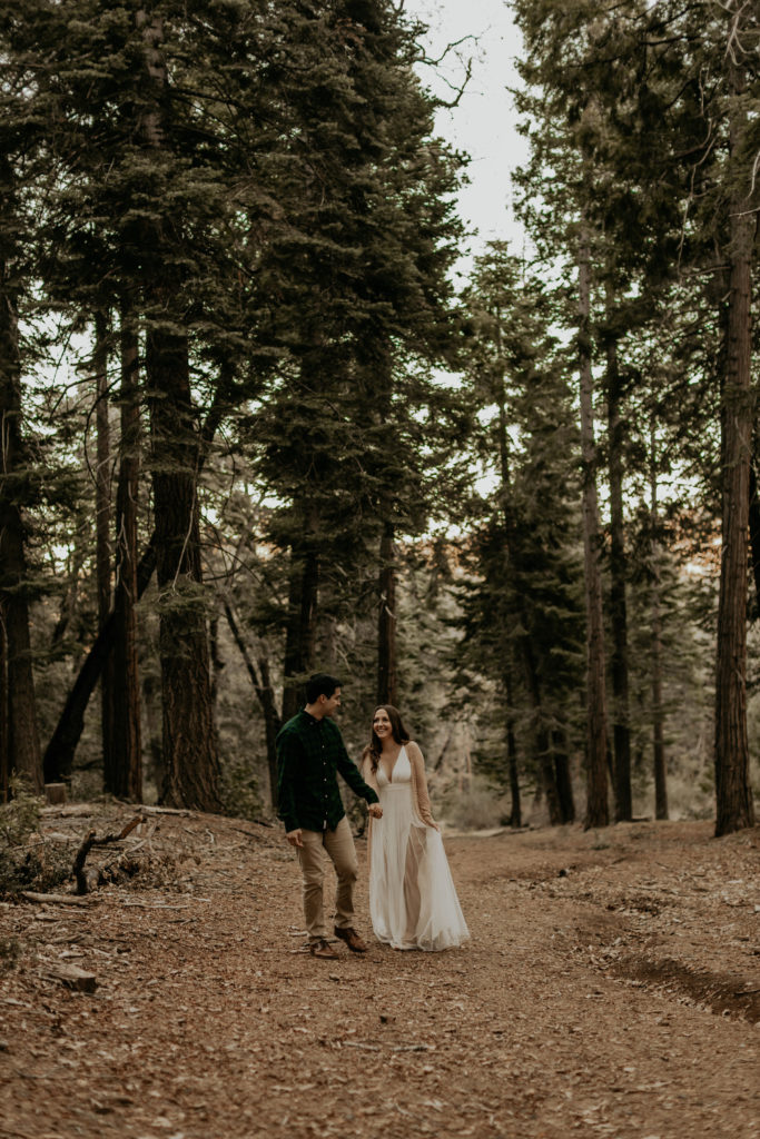 couple walking through the trees in california 