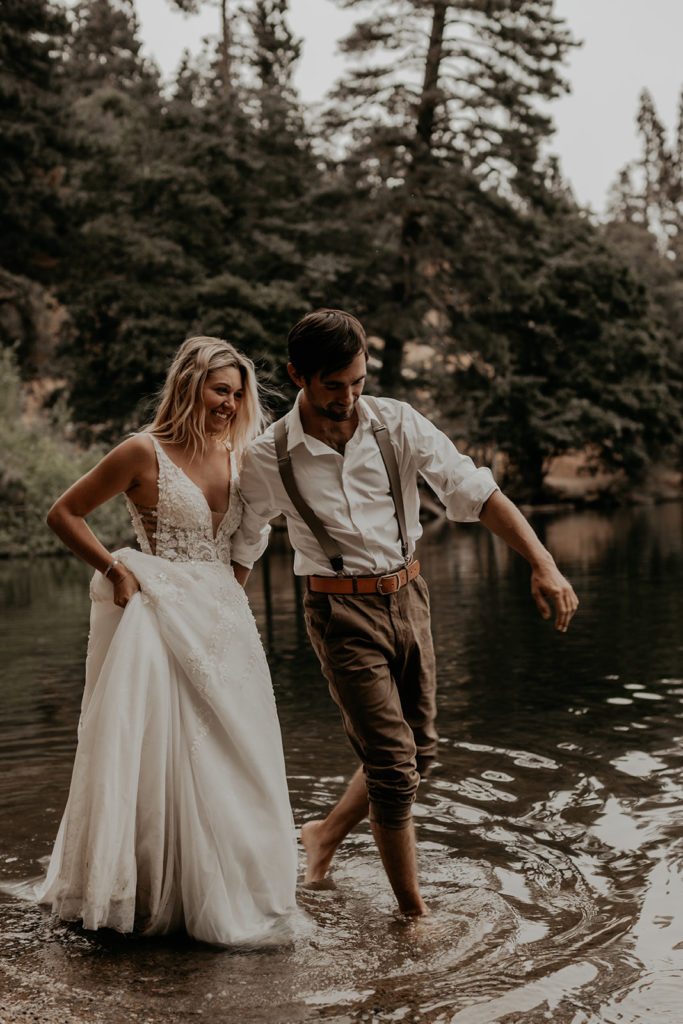 bride and groom walking in the lake