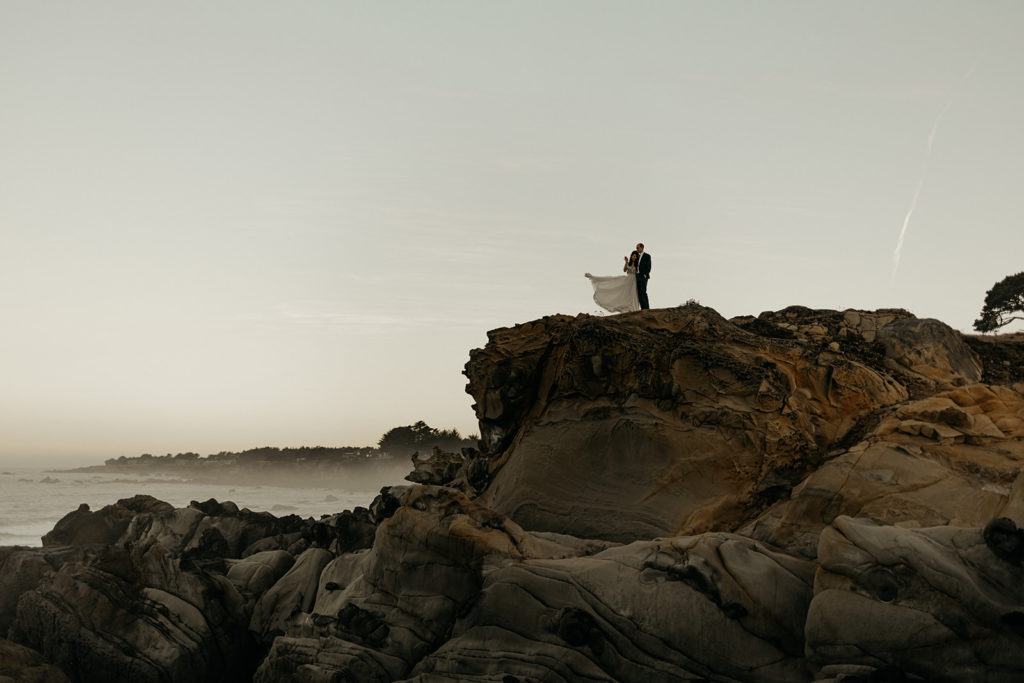 beach sunrise elopement couple holding eachother 
